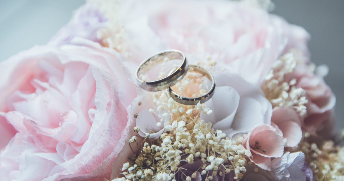 bridal ring set on pink rose flower bouquet